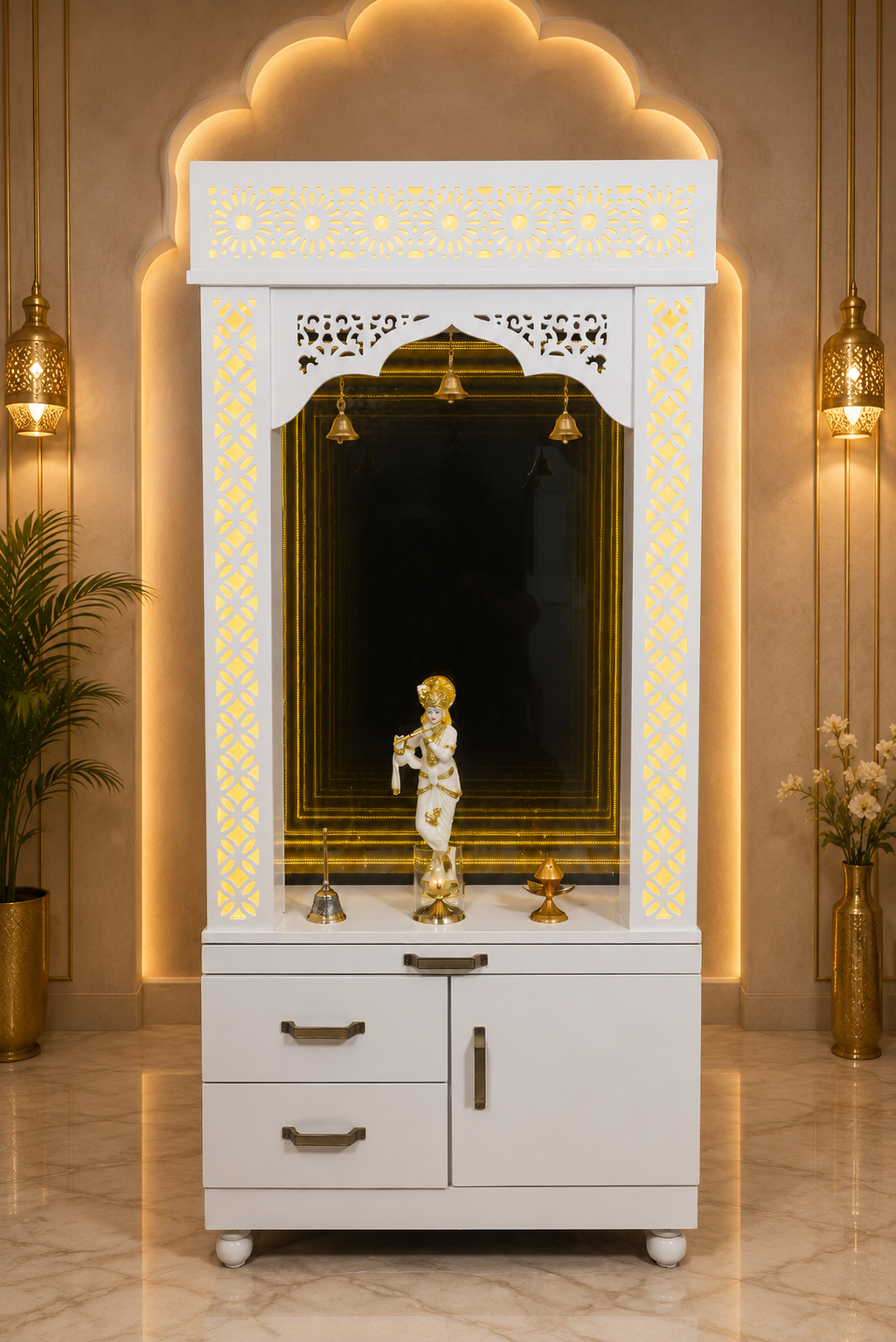 A white and gold Hindu home altar (Havan) cabinet with a decorative mirror, a child statue, and brass bell accents, set against a warm beige wall with built-in LED lighting.