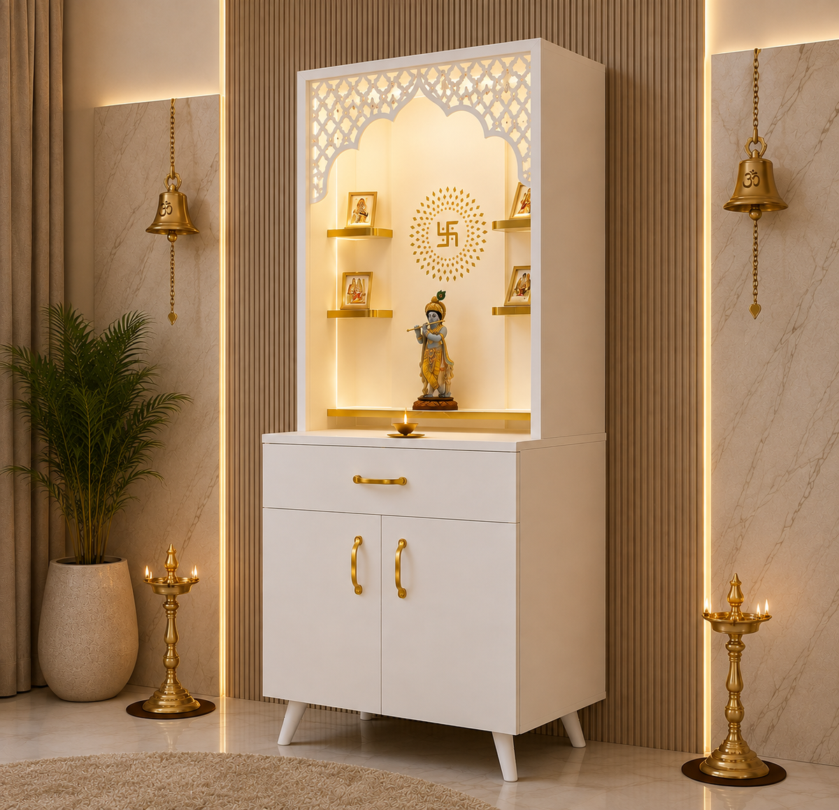 A white wooden Shiva mandir altar cabinet with gold accents, featuring a carved arched niche with a swastika symbol, decorative shelves, and a small statue, set against a beige paneled wall with warm ambient lighting.