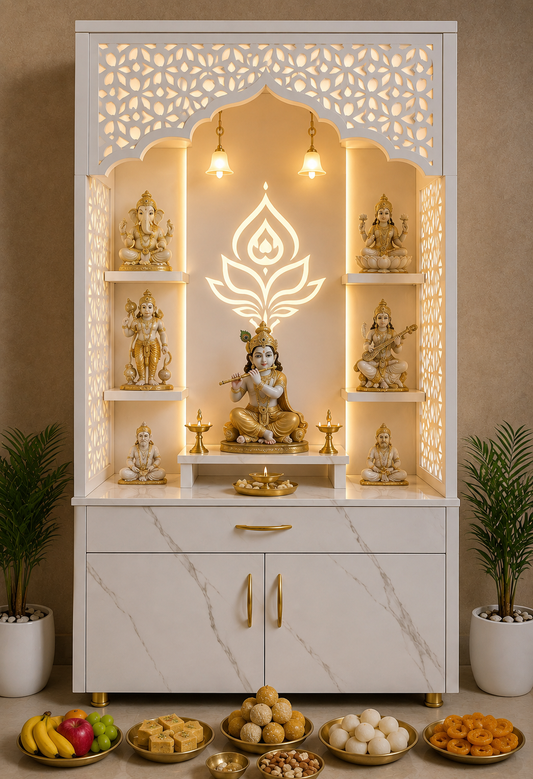A white and gold Hindu deity altar (holy of worship) cabinet featuring carved arched shelves with illuminated LED lights, gold-tone statues of various deities, and a central Lord Ganesha idol. The cabinet has marble-look doors with gold handles and sits on a wooden base.