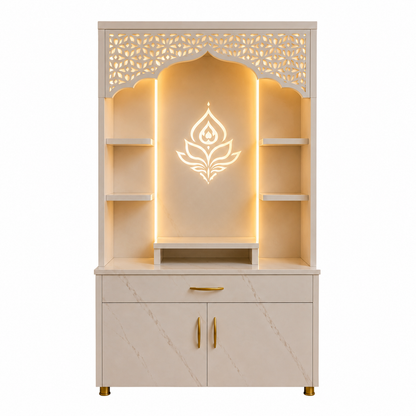 A cream-colored wooden Shiva mandir altar cabinet with gold handles, featuring a carved arched top with laser-cut floral patterns, built-in side shelves, a central niche with warm LED backlighting and a lotus emblem, and marble-look lower cabinet doors.