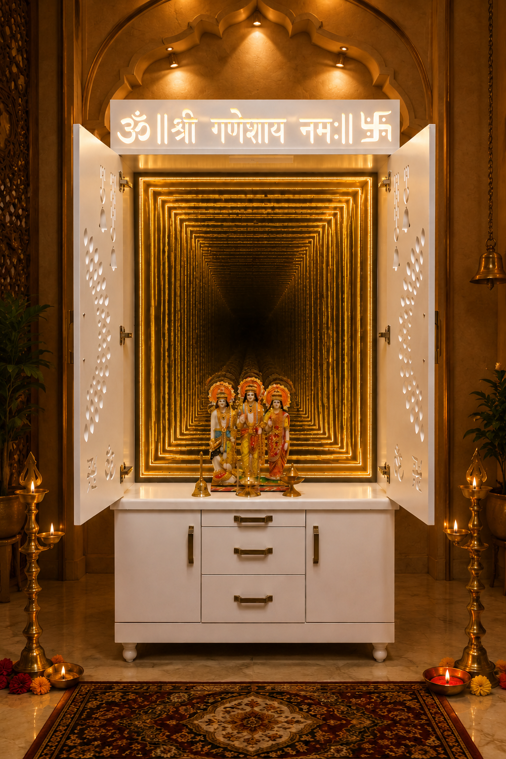 A white wooden Shree Ganesh Uchchatra cabinet with brass handles, featuring a white LED sign with Devanagari text at the top and a golden framed mandala design in the background. The cabinet is decorated with a small figurine of Lord Ganesha and surrounded by brass oil lamps, plants, and a patterned rug.